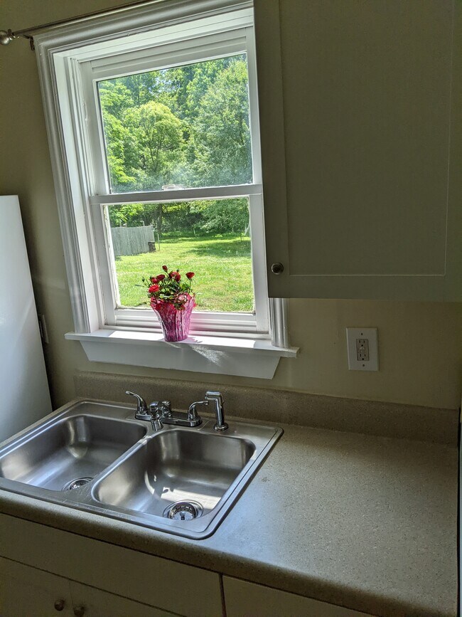 Cozy kitchen overlooks the large back yard