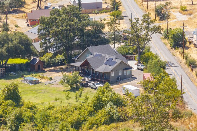 Butte Creek Canyon homeowners keep a vegetation barrier between their homes and the main road.