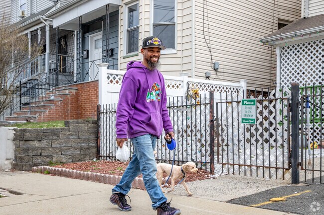A local resident enjoys a stroll through West Side, walking their dog along the neighborhood’s quiet streets.