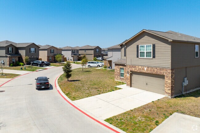 A winding road two-story wood sided homes located in Sonterra.