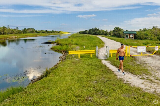 A man walks amongst nature in the Eastpointe neighborhood of Palm Beach Gardens, FL.