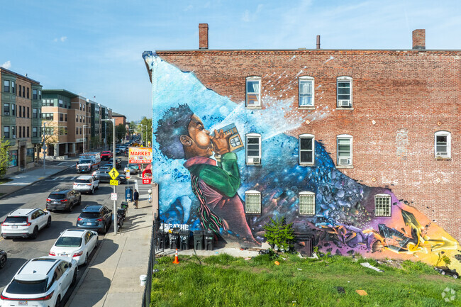 Murals burst with vibrant colors on the sides of numerous brick buildings throughout Sav-Mor.