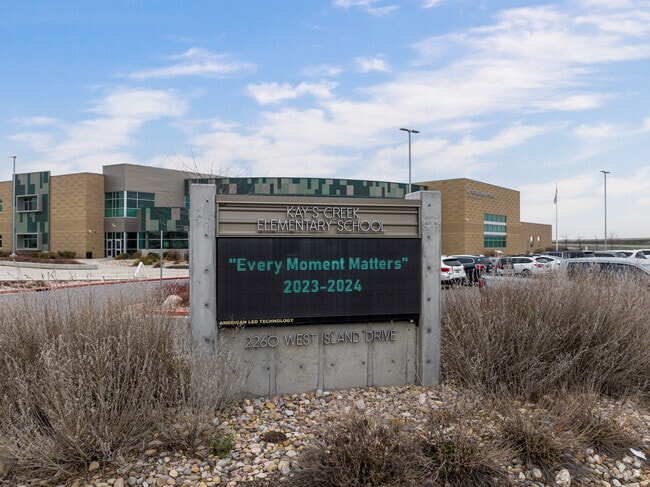 An electronic sign supported by a concrete base sits in fronto of Kay’s Creek Elementary School