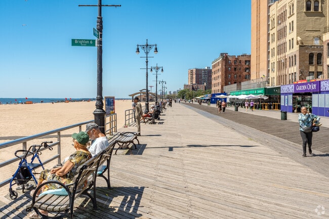 Explore 2.7 miles of boardwalk with scenic ocean views and local eateries at Brighton Beach.