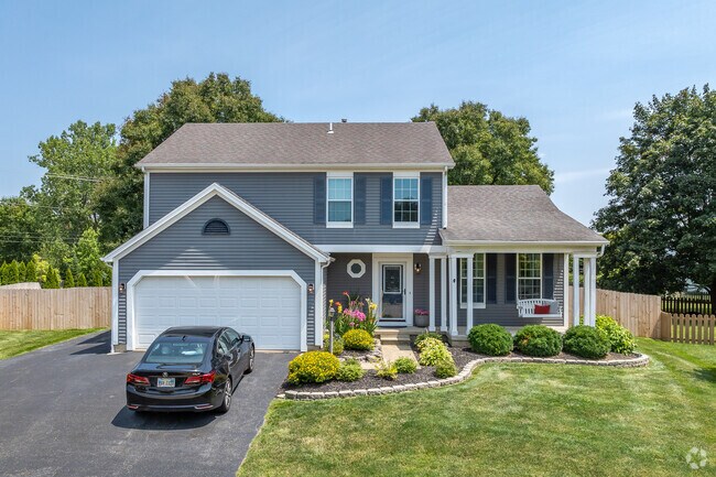 A two-story contemporary home in Worthington Green features beautiful landscaping.