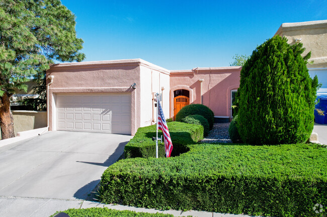 A Crestview Heights home with wooden security door and hedges in Onate.