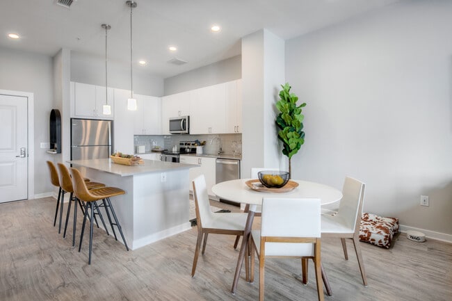 Scheme 1 kitchen with quartz countertops, tile backsplash, stainless steel appliances and hard surface flooring