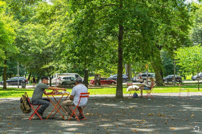 Friends gather for lunch at the picnic tables that are scattered throughout Clark Park.