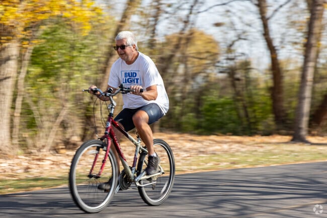 Bikers whiz by on the trails surrounding Ivy Hill's Lake Arlington park.