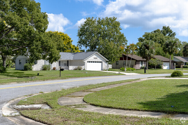 This row of Georgetowne homes enjoys shade and privacy from mature trees.