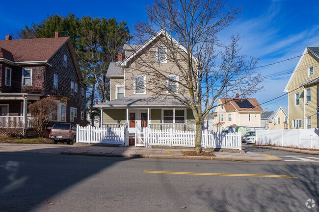 Many multi-family homes in Belmont have fenced-in front yards and front porches.