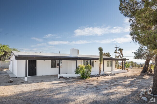 Ranch-style house painted in a modern black and white exterior seen in Joshua Tree.