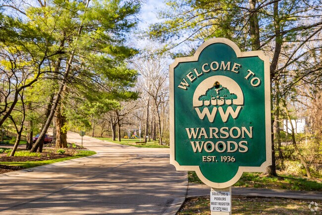 Warson Woods neighborhood sign on a tree lined street
