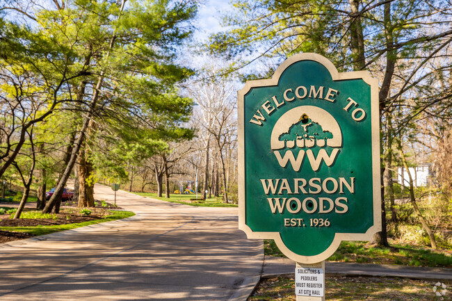 Warson Woods neighborhood sign on a tree lined street