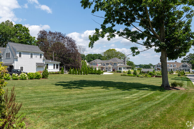 This row of spacious homes in the Rumstick neighborhood has water views and rolling lawns.