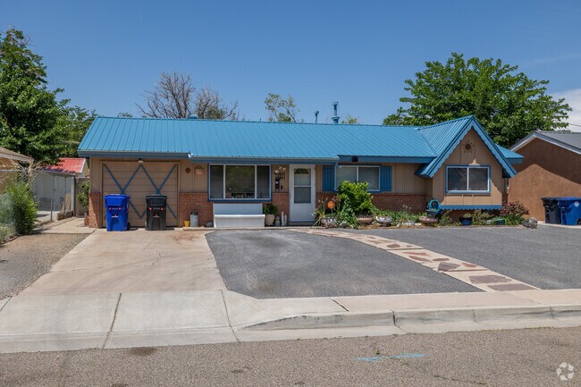 A blue metal roof adds a pop of color on a compact South Los Altos home.