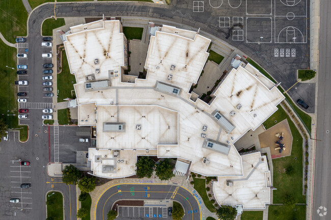An aerial view shows the layout of North Ogden School surrounded by parking lot and outdoor area