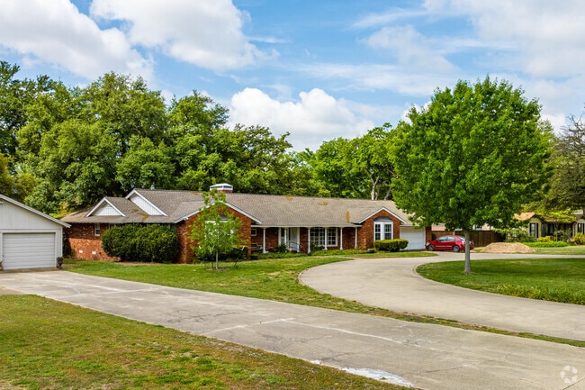 Ranch style homes sit below mature trees in Edgecliff Village.