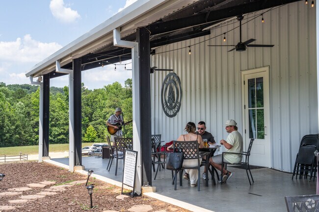 Enjoy a glass of wine on the patio while listening to live music at Qualusi Vineyards.
