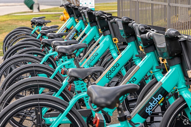 Locals often rent an electric bike by Gotcha bike share to commute around Highland Farms.