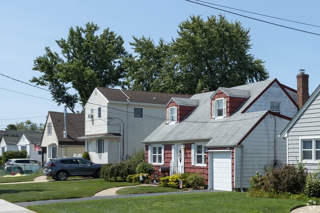 Rows of cape cod style homes are popular in Copiague, NY.