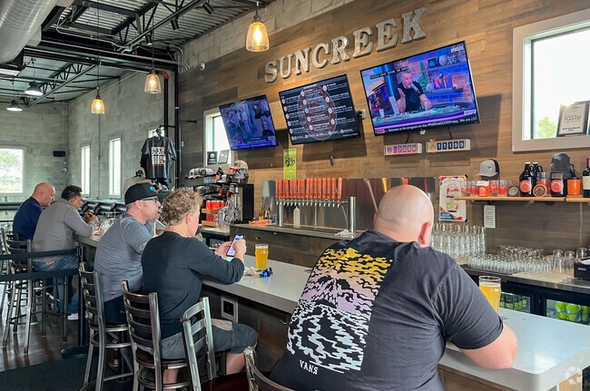 Clermont residents savor the draft beer selection at Suncreek Brewery.