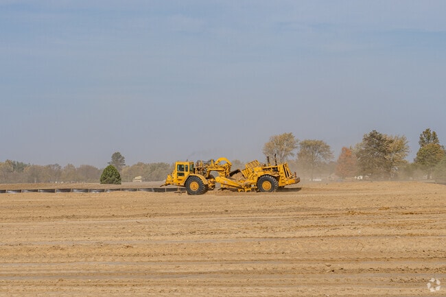 Construction vehicles are found grading land for new housing developments in Mount Comfort.