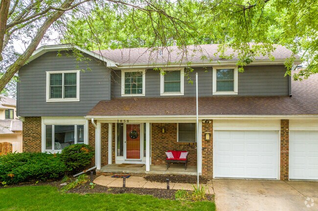 Quaint two-story homes are tucked into the large trees of Harvey Oaks.