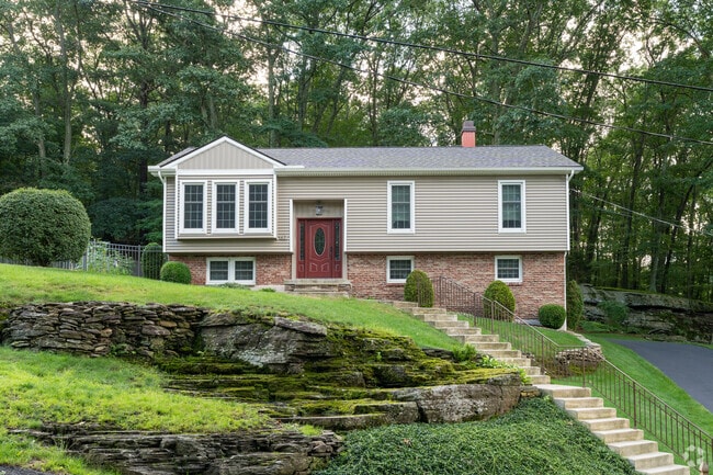 This split level home in Shavertown sits high on a hill lined with beautiful stone walls.