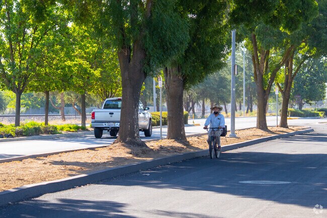 Bicyclists can cruises down a quiet residential street in North Madera.