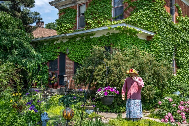 Wave to Daisy, the local garden mannequin who changes with the seasons, as you walk through Holy Trinity Longfellow.