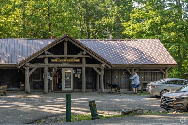 A man and his dog wait outside the Overlook Trading Post in Coopers Rock Forest near Cheat Lake.