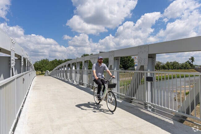 Bike along Deeds Point Metropark tranquil paths, framed by lush greenery and flowing fountains.