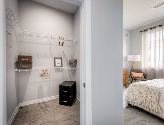 Walk-in closet with linen racks and storage space