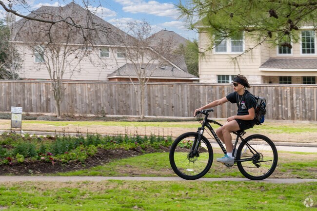 Neighbors in Cypress Creek Lakes ride bikes for relaxation and recreation.