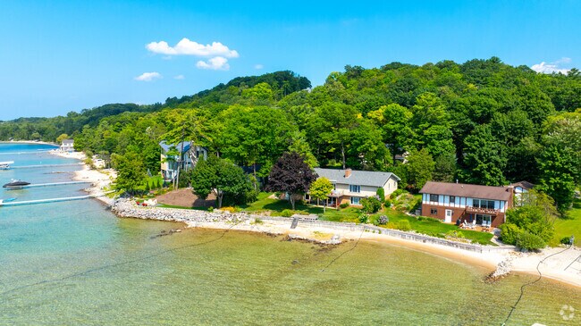Waterfront homes with private docks line Grand Traverse Bay on Old Mission Peninsula.
