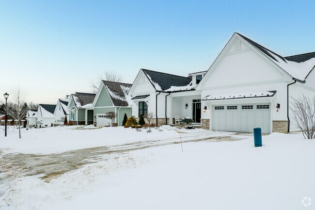 Single-family homes line a quiet Mayfield street, beautifully draped in seasonal snowfall.