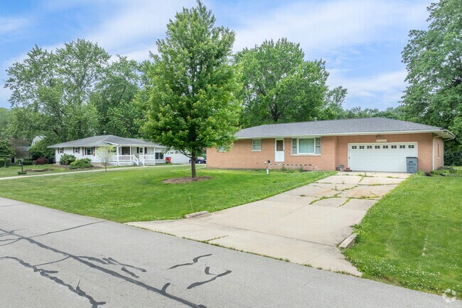 Older residential streets in Savoy were built without paved sidewalks for pedestrians.