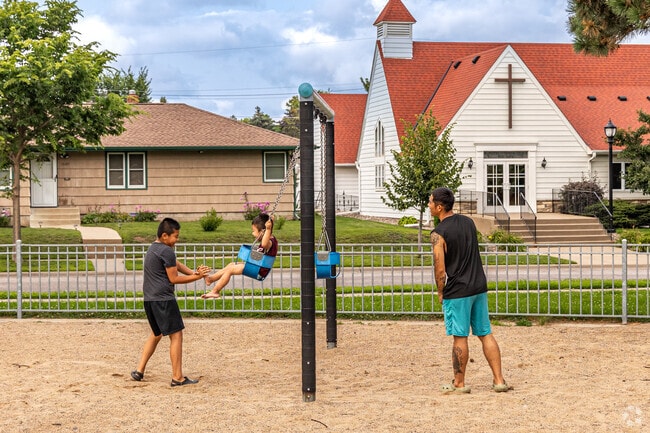 Families enjoy the playground at Prosperity Heights Park.