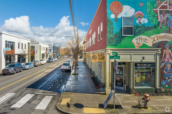 Looking Up NE Alberta St. in the Vernon Neighborhood shows murals on some of the walls.