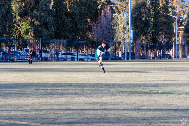 Future star Boy playing soccer at City Park in River Run.