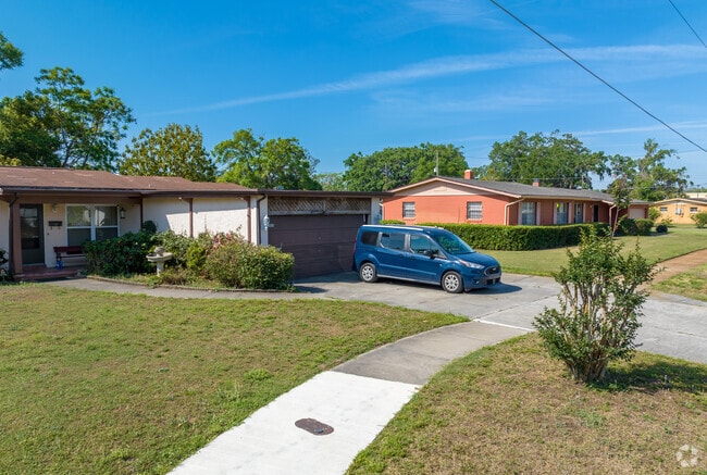 Older American Contemporary homes line the street surrounding Rock Lake