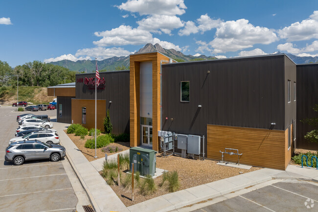 A side view of Wasatch Charter School shows big windows in many different shapes.