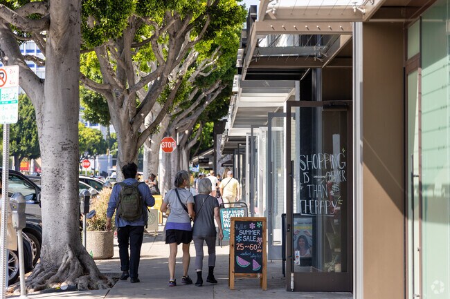 Larchmont Village's vibrant charm: People stroll along the sidewalk, exploring shops in Windsor