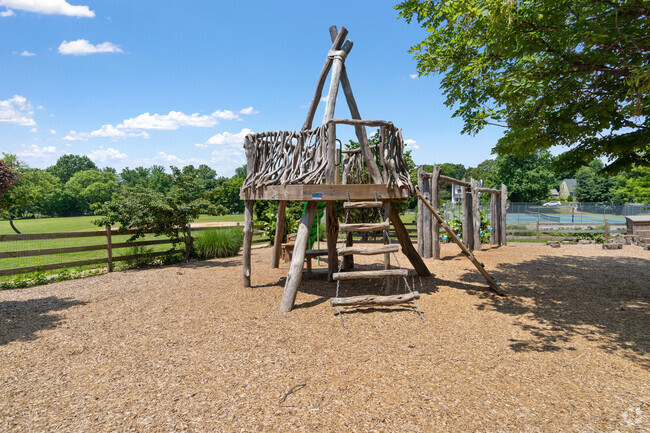 Redeemer School has a small playground built with logs.