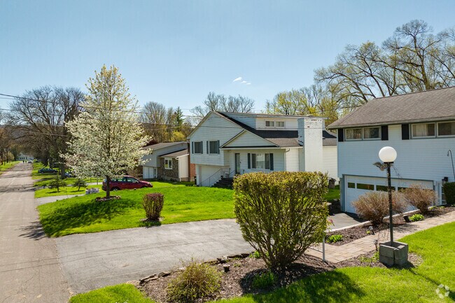 Many homes in Nedrow have elegantly manicured trees and bushes in their front yards.