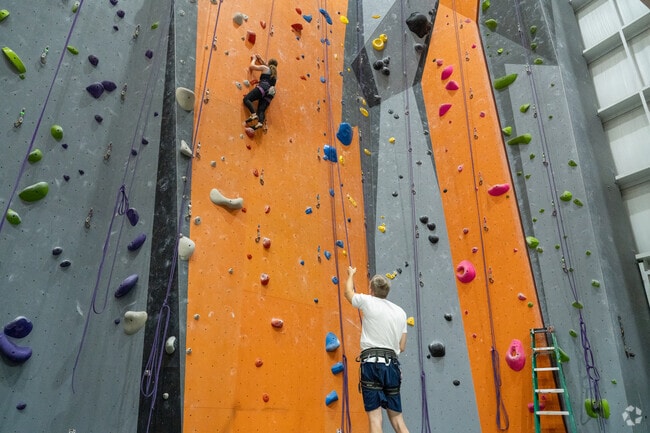 Dunham Pointe beginners and pros alike climb at InSPIRE Rock Climbing Gym.