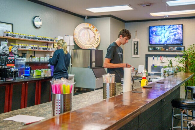 Inside Spot Nutrition in Pryor Creek, staff prep colorful drinks in a cozy welcoming space.