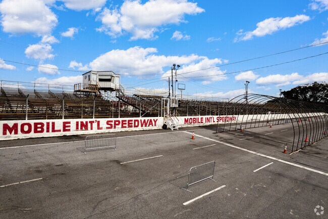 Stock car racing thrills fans at Mobile International Speedway.