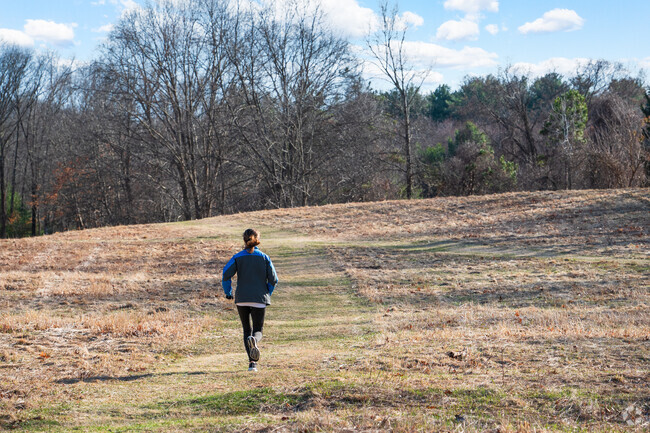 A resident enjoys a peaceful jog through Macomber Estate Park, a serene green space just off Salem End Road.